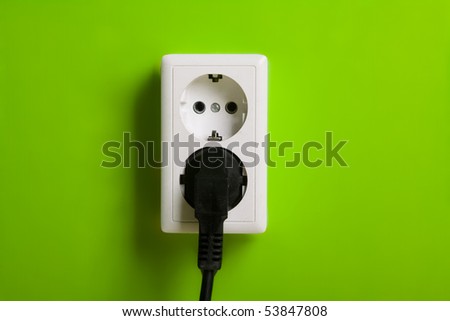 White electric socket on the wall. Close up.