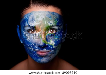 Girl with a painted map of World on his face. Closeup.