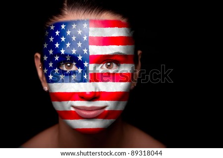 Portrait of a woman with the flag of the USA painted on her face.