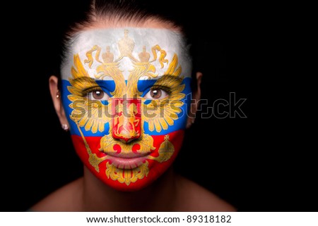 Portrait of a woman with the flag of the Russia painted on her face.