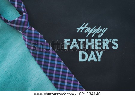 Father\'s Day graphic for celebration of holiday.  Includes plaid tie on black background with text.
