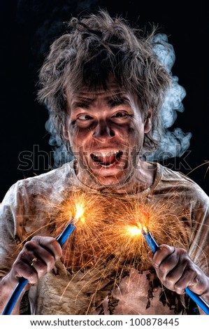Portrait of crazy electrician over black background