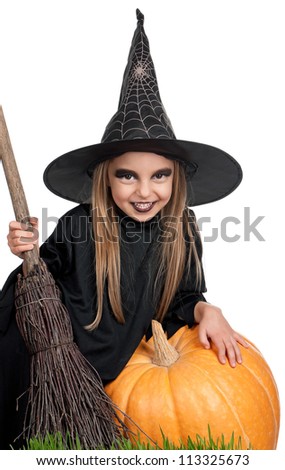 Portrait of little girl in black hat and black clothing with pumpkin on white background