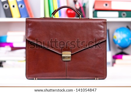 Brown leather briefcase on the table at office