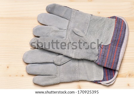 Close up of working gloves against wooden surface