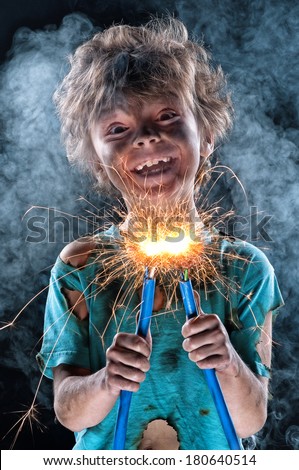 Portrait of little crazy electrician over black background