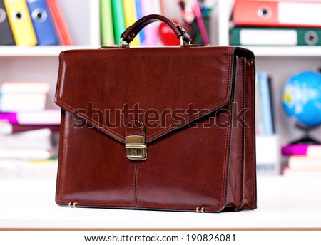 Brown leather briefcase on the table at office