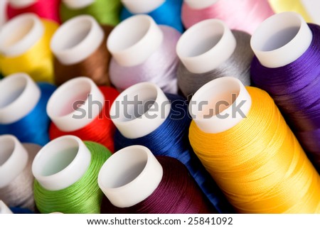 Hanks of multi-coloured threads for embroidery on a white background