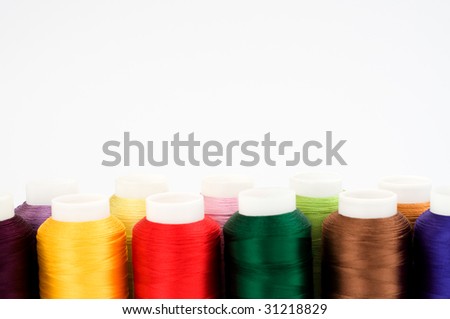 Hanks of multi-coloured threads for embroidery on a white background