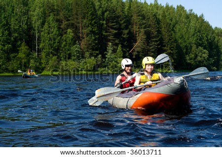 Kayakers sporting a kayak cuts through water