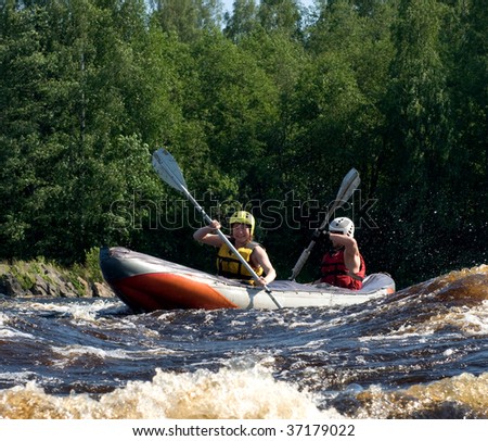 Kayakers sporting a kayak cuts through water