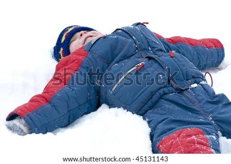 Boy playing in the snow, angel
