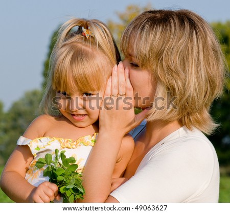 Daughter listening to her mother\'s secret whispers