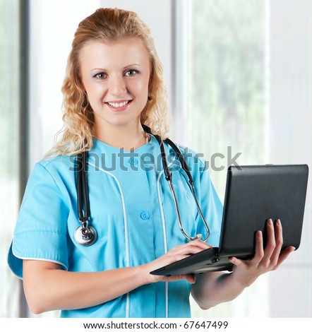 Beautiful young doctor with laptop and stethoscope in hospital