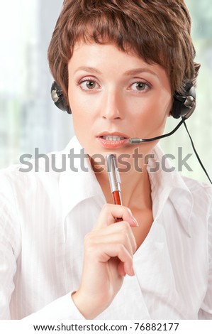 Portrait of a friendly woman with headset at her office