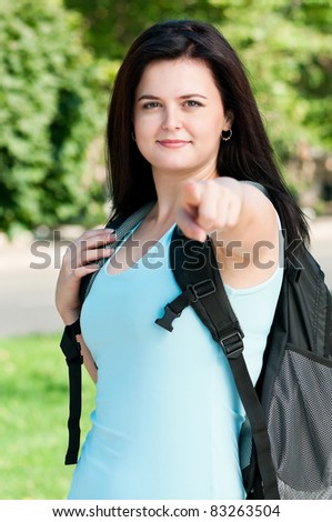 Portrait of a young female student with bag at the campus