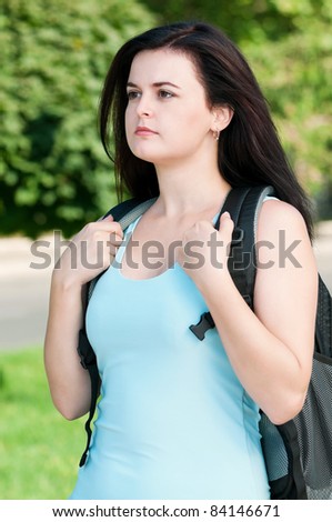 Portrait of a young female student with bag at the campus