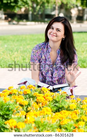 Portrait of a young female student with books at the campus