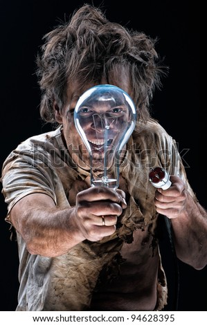 Portrait of funny electrician over black background