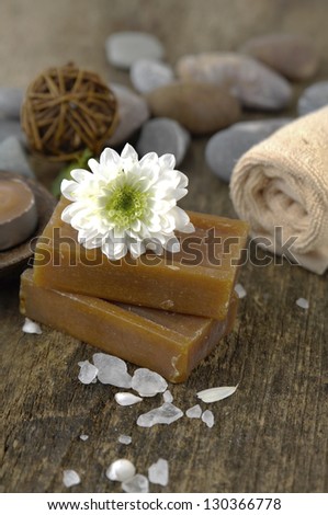 flower on soap, towel, soap ,stones, white flower petals on old wooden