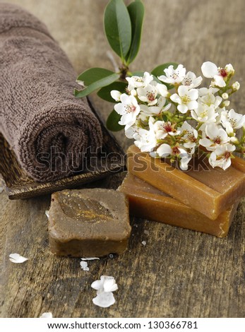 flower on soap, towel, soap on old wooden
