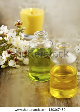 Set of bunch of spring flower with massage oil on old wooden
