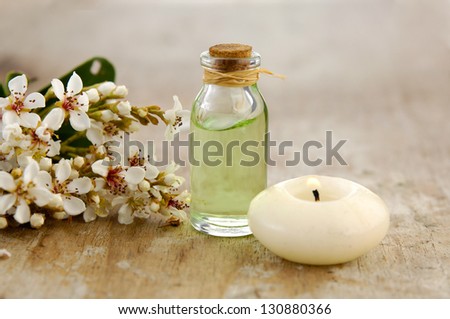 Tropical spring flower, white candle, massage oil