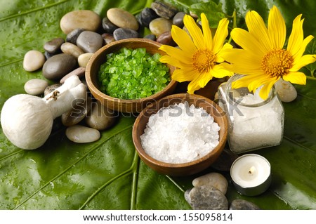 spa supplies with yellow orchid . salt in bowl ,massage ball,leaf