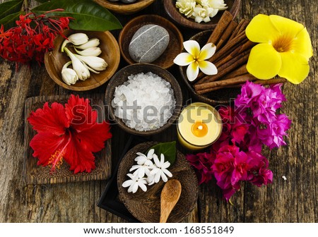 Tropical Spring flower with soap, salt in bowl ,candle, on old wooden