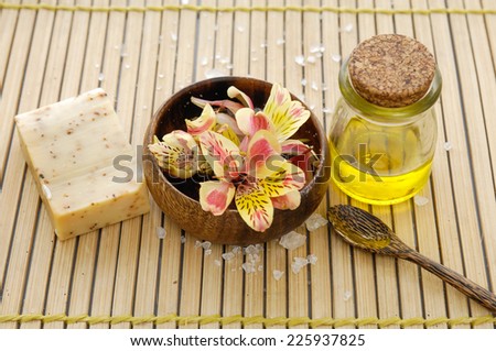orchid flower in wooden bowl with soap ,oil on mat