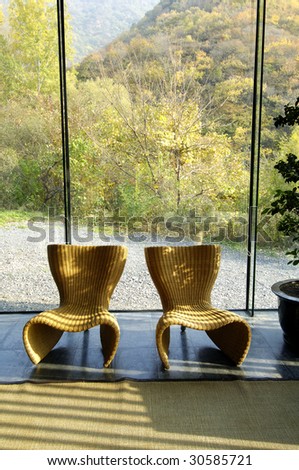 chair for two by big window in rustic restaurant