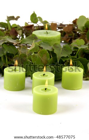 Decoration-ivy and green candle on white