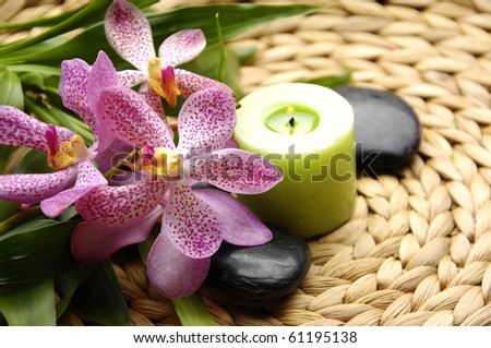 Spa resort composition - candles, orchid flowers, zen stones