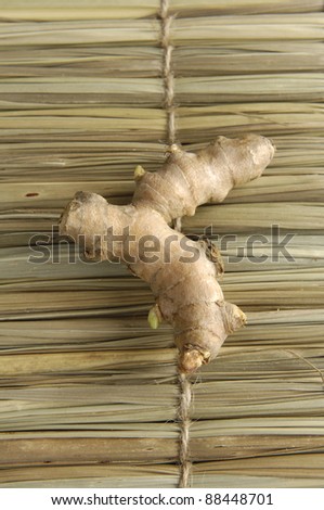 ginger root on texture of straw.