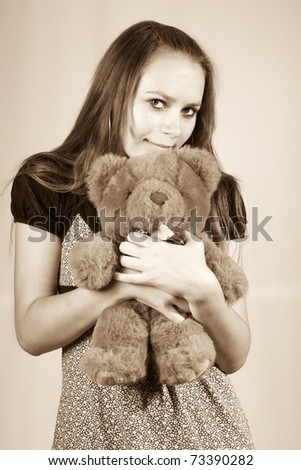 Portrait of the beautiful girl with a toy a bear Teddy.
