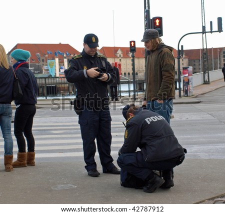 COPENHAGEN - DEC 12: Police stop and search a bag belonging to a young man before the protest marches  during the Climate Conference on December 12, 2009 in Copenhagen