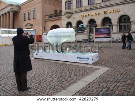 COPENHAGEN - DEC 12:  A man takes a photo of the Ice Bear which is part of the WWF exhibit which takes place during the UN Conference on Climate Change on December 12, 2009 in Copenhagen.
