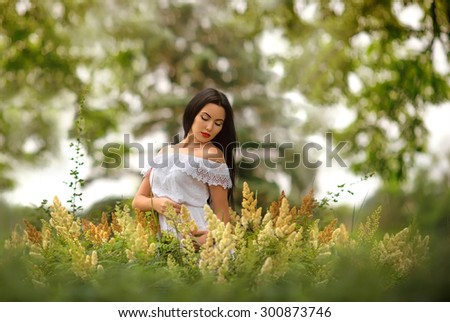 beautiful young girl among the high grass. view girl pointing down