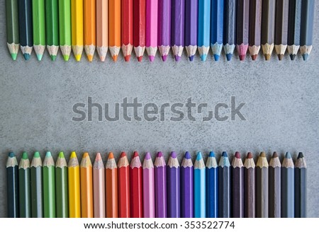 Line of colored pencils, Colour pencils on gray tile surface background close up - copy space & Your text design