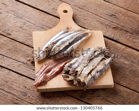 Marinated anchovies on wooden table