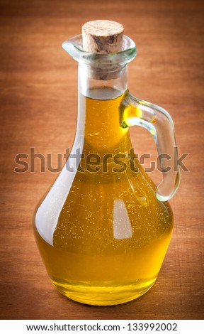 Olives and a bottle of olive oil isolated on wooden table