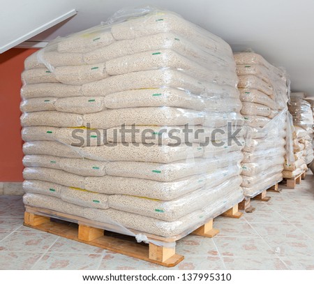 Pallets of wood pellets in plastic bags