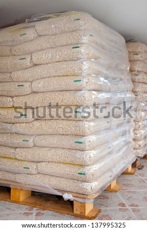 Pallets of wood pellets in plastic bags