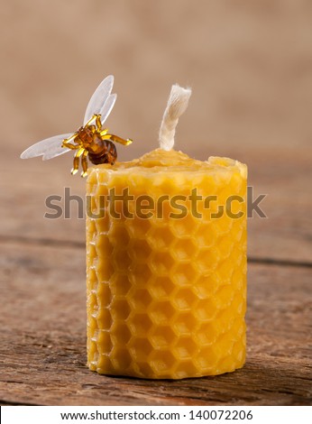Beeswax candles on wooden table