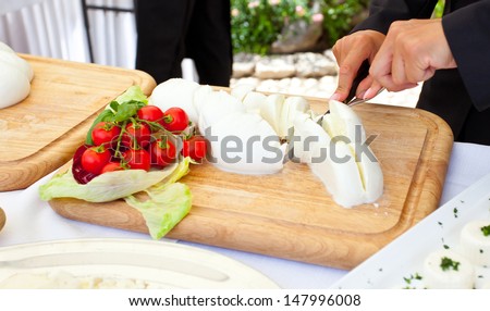 Sliced of Mozzarella from the waiter during a wedding reception