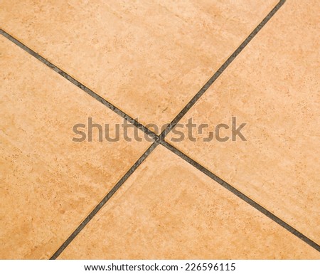 Brown ceramic floor tiles close up texture.