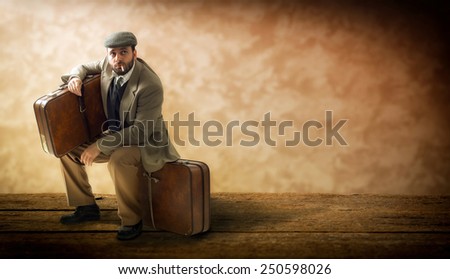 Emigrant with cardboard suitcases on a wooden floor.
