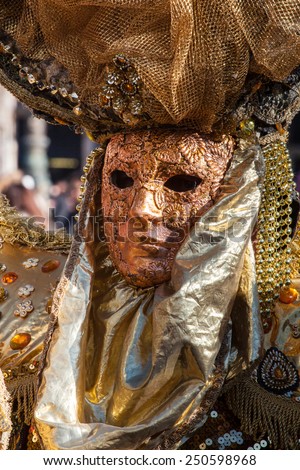 Golden mask with decorations and carvings during the Carnival of Venice 2015 edition.