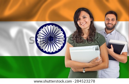 Couple of young students with books over indian flag
