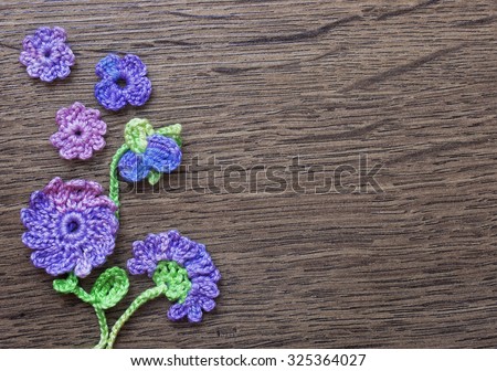 Colorful original crochet handmade background with flowers and leaves/ photo macro/ crochet colorful elements